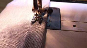 process of sewing in a sewing machine sew woman's hands manicure black textile denim jeans manufacturing close up seamstress in workshop fabric clothes making design hobby handmade working needlework video