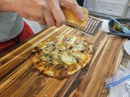 Home made stone baked barbecue pizza with fresh dough and meet vegetables and cheese photo