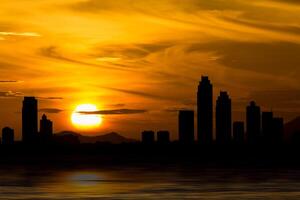 Dramatic Pattaya Thailand skyline behind clouds above the sea photo