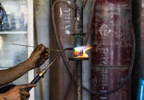 Welders were repairing cutting Shock absorbers photo