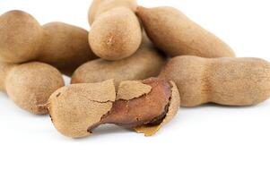 Tamarind whole and cracked open on white background photo