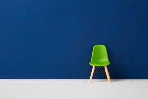 Green chair against a blue wall. Business Concept photo