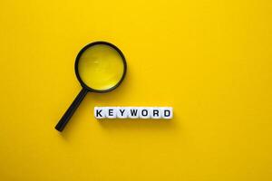 Block of Keyword on yellow background. Conceptual image of the importance of the keywords. photo