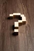 Forming bigger question mark. question mark on wooden table background photo