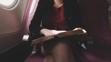 Asian young woman using laptop sitting near windows at first class on airplane during flight,Traveling and Business concept video