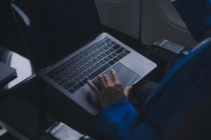 Using mobile and laptop, Thoughtful asian people female person onboard, airplane window, perfectly capture the anticipation and excitement of holiday travel. chinese, japanese people. photo