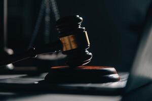 Business and lawyers discussing contract papers with brass scale on desk in office. Law, legal services, advice, justice and law concept picture with film grain effect photo