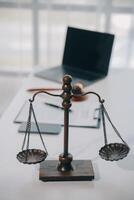 Business and lawyers discussing contract papers with brass scale on desk in office. Law, legal services, advice, justice and law concept picture with film grain effect photo