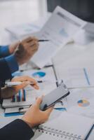 Financial analysts analyze business financial reports on a digital tablet planning investment project during a discussion at a meeting of corporate showing the results of their successful teamwork. photo