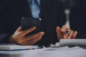 Financial analysts analyze business financial reports on a digital tablet planning investment project during a discussion at a meeting of corporate showing the results of their successful teamwork. photo