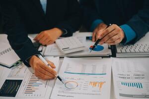 Financial analysts analyze business financial reports on a digital tablet planning investment project during a discussion at a meeting of corporate showing the results of their successful teamwork. photo