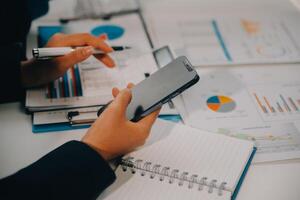 Financial analysts analyze business financial reports on a digital tablet planning investment project during a discussion at a meeting of corporate showing the results of their successful teamwork. photo