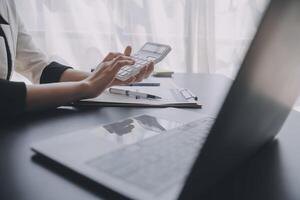 Financial analysts analyze business financial reports on a digital tablet planning investment project during a discussion at a meeting of corporate showing the results of their successful teamwork. photo