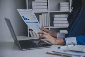 Financial analysts analyze business financial reports on a digital tablet planning investment project during a discussion at a meeting of corporate showing the results of their successful teamwork. photo