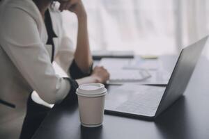 Financial analysts analyze business financial reports on a digital tablet planning investment project during a discussion at a meeting of corporate showing the results of their successful teamwork. photo