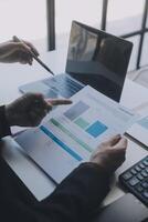 Financial analysts analyze business financial reports on a digital tablet planning investment project during a discussion at a meeting of corporate showing the results of their successful teamwork. photo