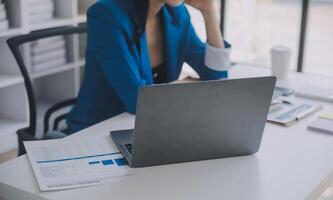 Financial analysts analyze business financial reports on a digital tablet planning investment project during a discussion at a meeting of corporate showing the results of their successful teamwork. photo
