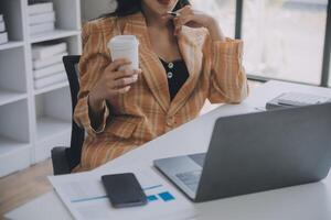Financial analysts analyze business financial reports on a digital tablet planning investment project during a discussion at a meeting of corporate showing the results of their successful teamwork. photo