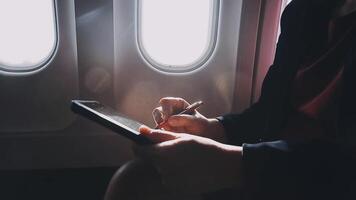 Asian young woman using laptop sitting near windows at first class on airplane during flight,Traveling and Business concept video