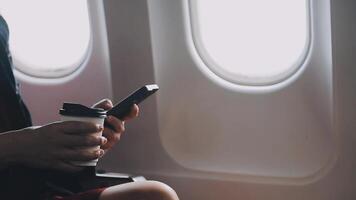 Asian young woman using laptop sitting near windows at first class on airplane during flight,Traveling and Business concept video