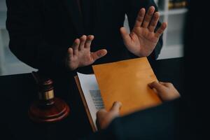 Justice and law concept.Male judge in a courtroom with the gavel, working with, computer and docking keyboard, eyeglasses, on table in morning light photo