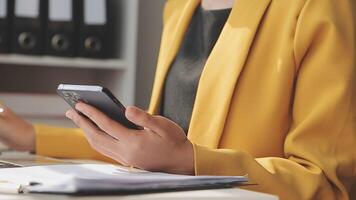 Business team working with new startup project plan and discussion information for financial strategy with laptop and digital tablet in a modern business lounge. video