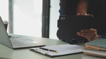Business team working with new startup project plan and discussion information for financial strategy with laptop and digital tablet in a modern business lounge. video