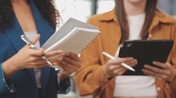 Business team working with new startup project plan and discussion information for financial strategy with laptop and digital tablet in a modern business lounge. video