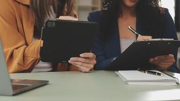 Business team working with new startup project plan and discussion information for financial strategy with laptop and digital tablet in a modern business lounge. video