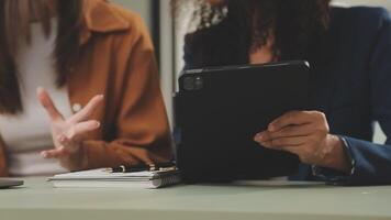 Business team working with new startup project plan and discussion information for financial strategy with laptop and digital tablet in a modern business lounge. video