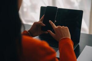 Asian Business woman using calculator and laptop for doing math finance on an office desk, tax, report, accounting, statistics, and analytical research concept photo