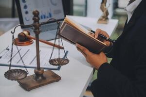 Business and lawyers discussing contract papers with brass scale on desk in office. Law, legal services, advice, justice and law concept picture with film grain effect photo