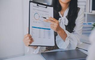 Business team collaboration discussing working analyzing with financial data and marketing growth report graph in team, presentation and brainstorming to strategy planning making profit of company. photo