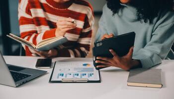 Finance manager meeting discussing company growth project success financial statistics, professional investor working start up project for strategy plan with document, laptop and digital tablet. photo