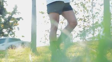 Athletic runner doing stretching exercise, preparing for running in the nature with the city in background. Healthy lifestyle video