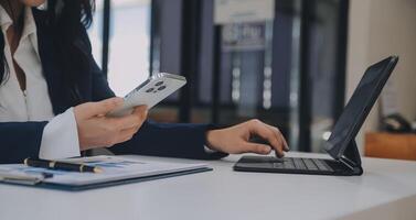 Financial analysts analyze business financial reports on a digital tablet planning investment project during a discussion at a meeting of corporate showing the results of their successful teamwork. photo