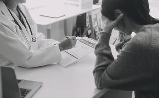 Close up serious doctor wearing medical face mask consulting mature woman patient at appointment in office, physician explaining treatment, giving recommendations, elderly generation healthcare photo