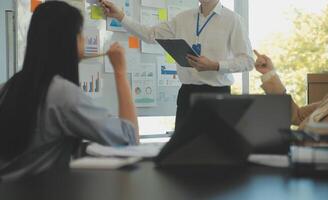 Business team collaboration discussing working analyzing with financial data and marketing growth report graph in team, presentation and brainstorming to strategy planning making profit of company. photo