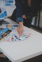 Close up ux developer and ui designer use augmented reality brainstorming about mobile app interface wireframe design on desk at modern office.Creative digital development agency photo