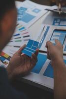 Close up ux developer and ui designer use augmented reality brainstorming about mobile app interface wireframe design on desk at modern office.Creative digital development agency photo