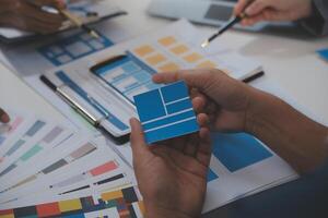 Close up ux developer and ui designer use augmented reality brainstorming about mobile app interface wireframe design on desk at modern office.Creative digital development agency photo