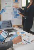 Close up ux developer and ui designer use augmented reality brainstorming about mobile app interface wireframe design on desk at modern office.Creative digital development agency photo