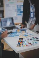 Close up ux developer and ui designer use augmented reality brainstorming about mobile app interface wireframe design on desk at modern office.Creative digital development agency photo