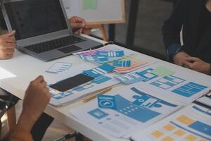 Close up ux developer and ui designer use augmented reality brainstorming about mobile app interface wireframe design on desk at modern office.Creative digital development agency photo