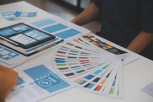 Close up ux developer and ui designer use augmented reality brainstorming about mobile app interface wireframe design on desk at modern office.Creative digital development agency photo