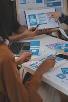 Close up ux developer and ui designer use augmented reality brainstorming about mobile app interface wireframe design on desk at modern office.Creative digital development agency photo