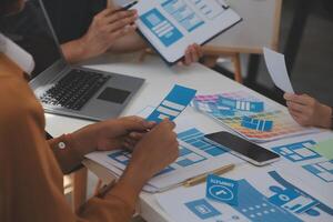 Close up ux developer and ui designer use augmented reality brainstorming about mobile app interface wireframe design on desk at modern office.Creative digital development agency photo
