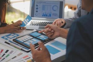 Close up ux developer and ui designer use augmented reality brainstorming about mobile app interface wireframe design on desk at modern office.Creative digital development agency photo