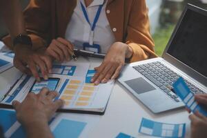 Close up ux developer and ui designer use augmented reality brainstorming about mobile app interface wireframe design on desk at modern office.Creative digital development agency photo