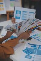 Close up ux developer and ui designer use augmented reality brainstorming about mobile app interface wireframe design on desk at modern office.Creative digital development agency photo